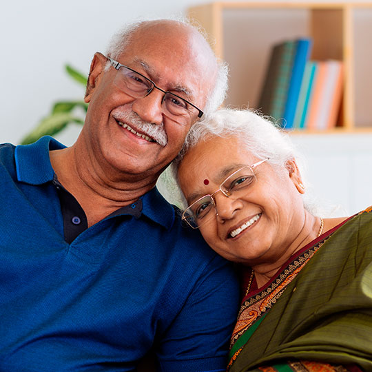 Portrait of senior Indian couple smiling and looking at the camera